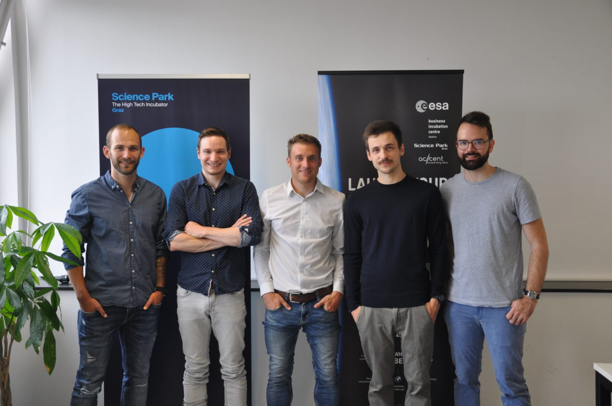 team members, 5 young men, in front of Science Park Graz rollup