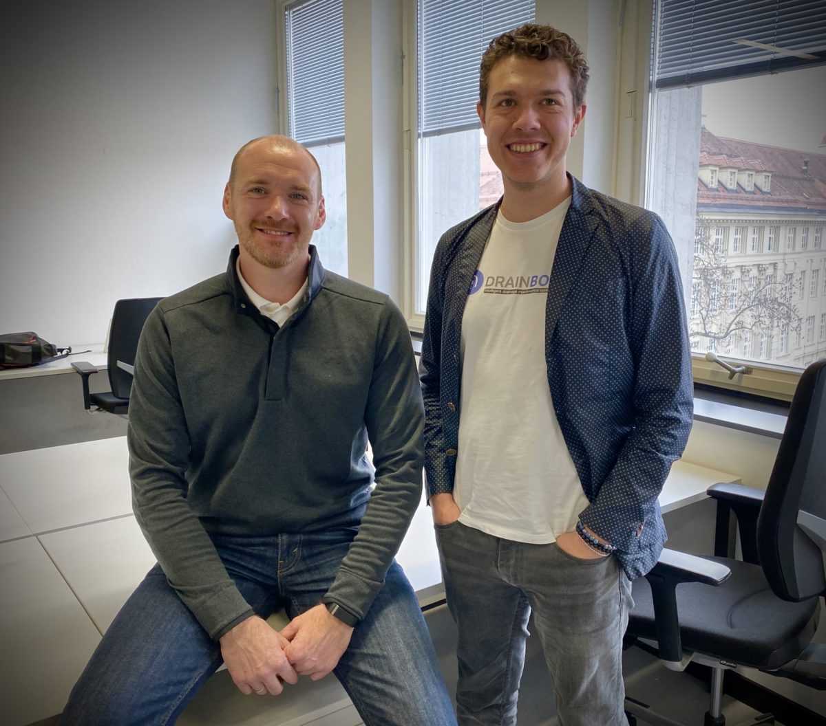 The two young founders in their office with big windows