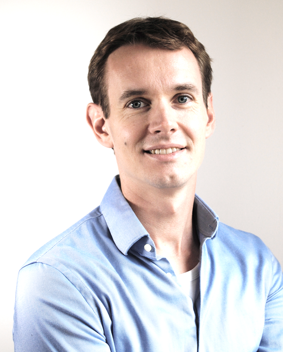 young man in blue shirt smiling