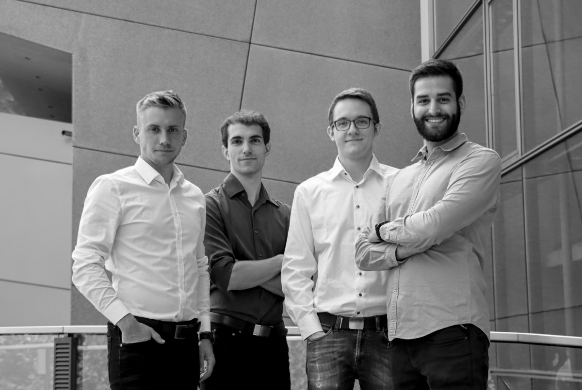 black and white photo of team, 4 young men in shirts