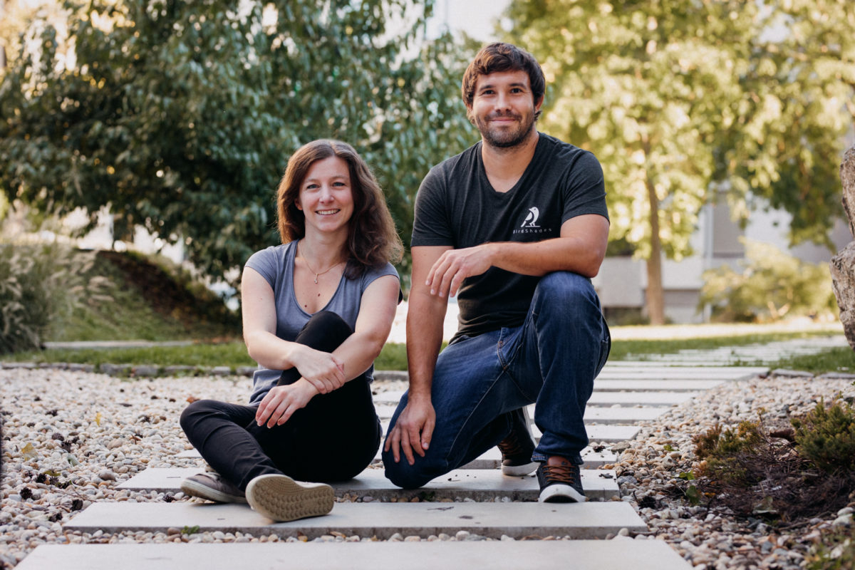 Woman and man sitting on a path made of stones in the sun