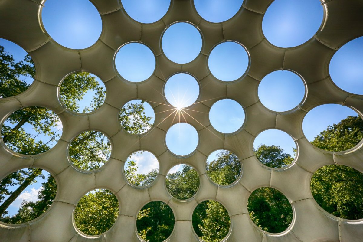 Sunburst shining through the holes in Buckminster Fuller's Geodesic creation at Crystal Bridges.