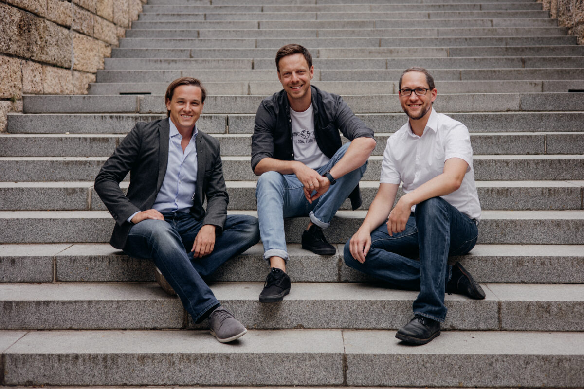 3 men, team ubicube, sitting outside on stairs